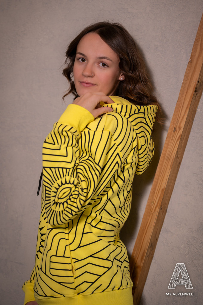 Yellow hoodie with black alpine world pattern all over the sweater
