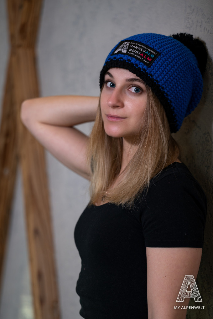 Blue and black wool hat with Alpenwelt, Susi Alm, and Hannes Alm logo patch