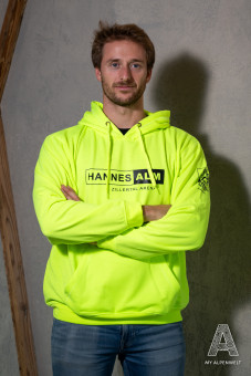 Neon yellow hoodie Front print: Hannes Alm & Zillertal Arena. Left sleeve print: Alpenwelt Resort logo