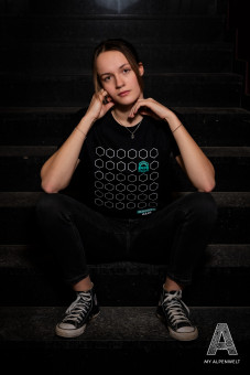 Black T-shirt with pattern and Hannes Alm logo on the front